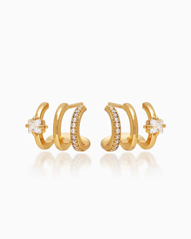 The Anya Huggies, gold illusion earrings that give you three petite hoops and styles in one