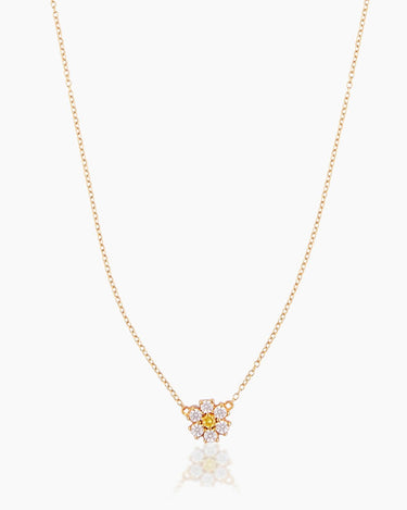 The Flora, a gold pendant necklace featuring a daisy-like flower crafted with cubic zirconia