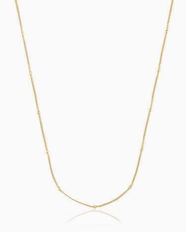 The Louisa Necklace, a classic gold beaded chain that offers an ultra-stackable minimalist style