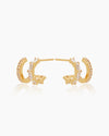 The Brooke Huggies, double stacked gold illusion earrings featuring both round cut and baguette cut cubic zirconia