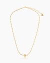 A full-length shot of the Erica, a minimalist and ultra-stackable gold necklace with a unique link chain and bead pendant