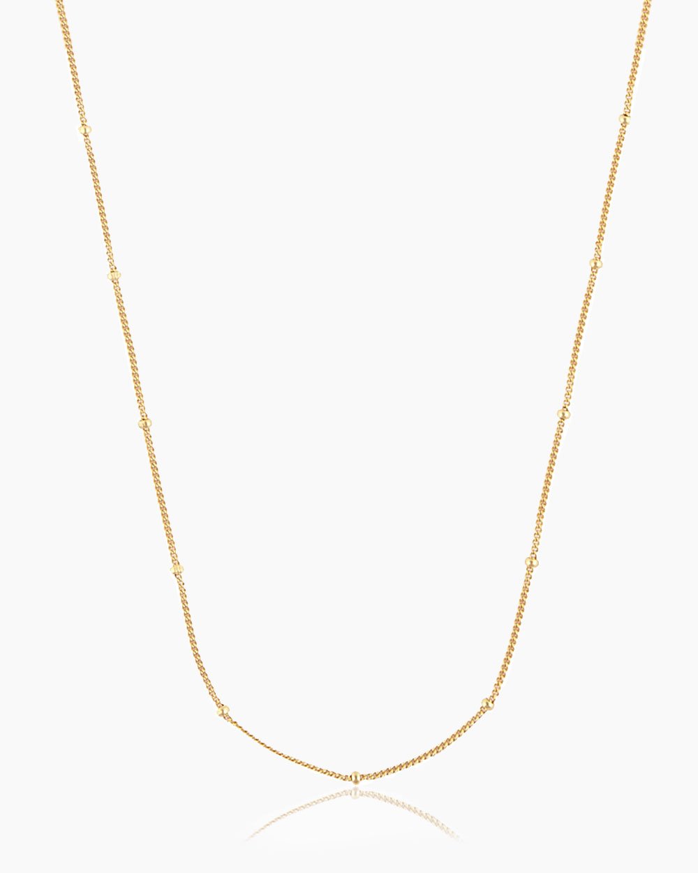 The Louisa Necklace, a classic gold beaded chain that offers an ultra-stackable minimalist style