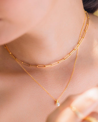 A woman wearing the Alicia Necklace layered with the Paperclip Necklace