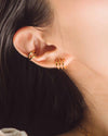 The Chelsea Huggies and Beth Cuffs worn on a woman's ear