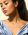 A woman wearing the Flora Necklace and Flora Studs