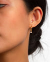The Kayla Huggies worn on a woman's left ear