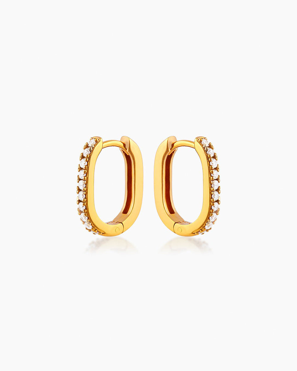 The Lucy Huggies, dainty gold earrings with a high-shine pavé-set finish and unique silhouette