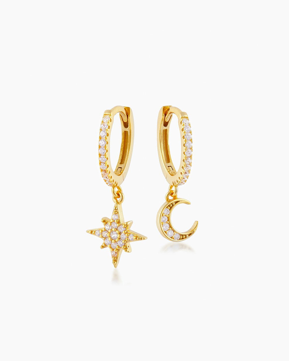 The Sky Huggies, gold drop earrings that feature star and moon charms on pavé-set ear-hugging hoops