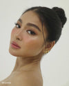 Nadine Lustre wearing the Venus Huggies, an oval-shaped gold earring from Penny Pairs